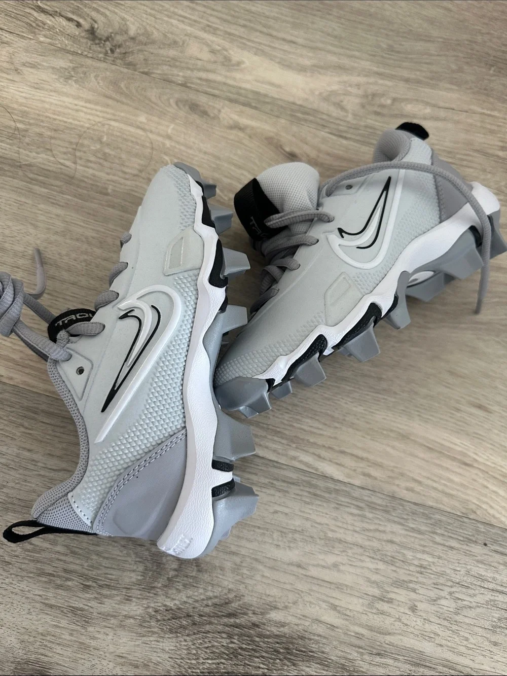 Nike Light Gray and White Cleats with Black Swoosh